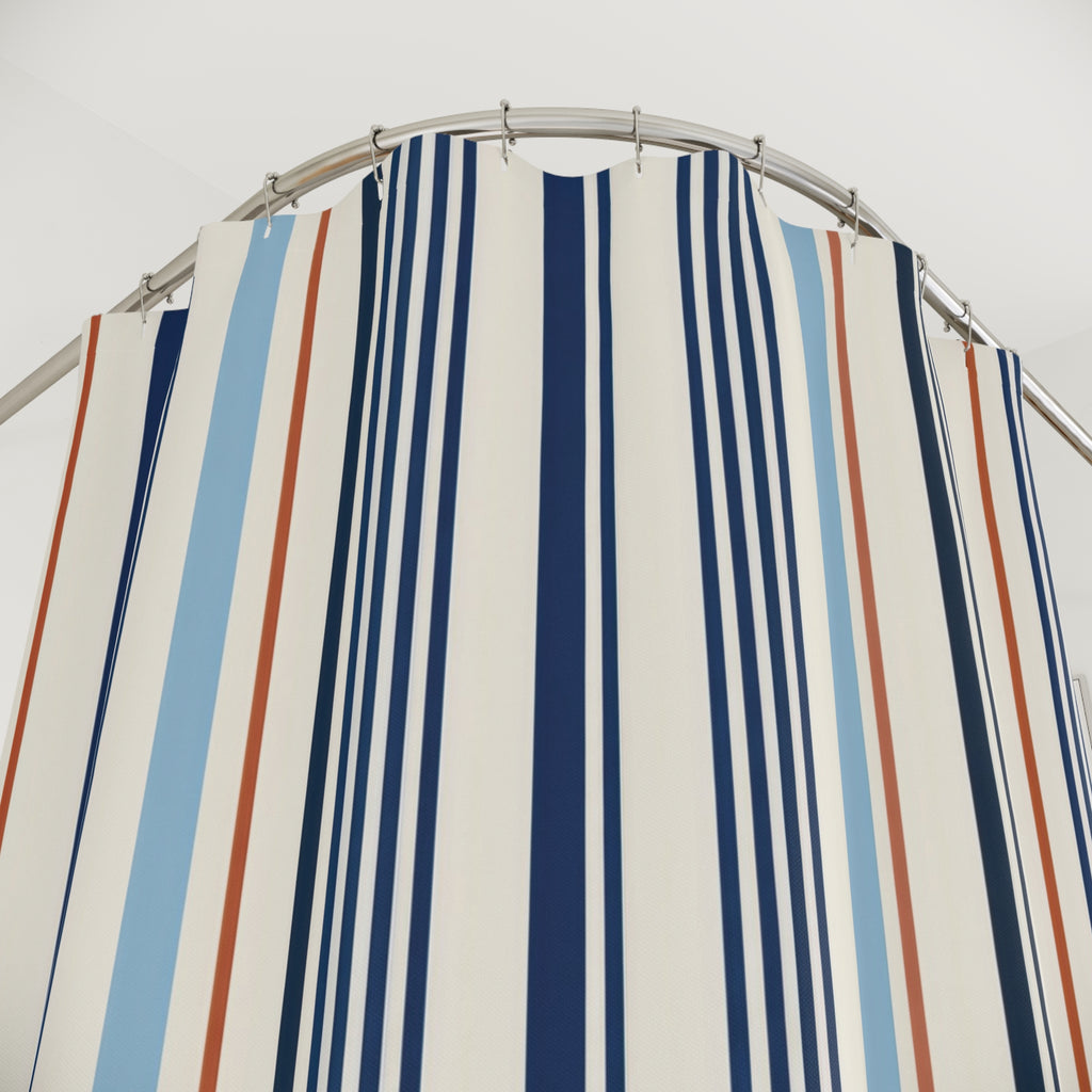 Navy pinstripes with blue and rust accents on ivory shower curtain with close-up print, hooks, and folds