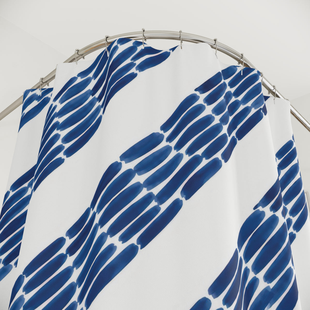 Diagonal indigo ink dashes and broad white stripes shower curtain with close-up print, hooks, and folds