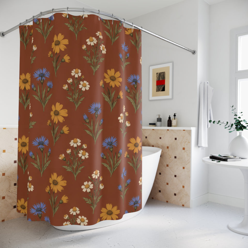 Ochre flowers, blue cornflowers and cream daisies on russet shower curtain beside a freestanding tub