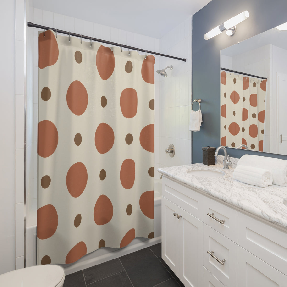Large terracotta circles and small brown dots on cream shower curtain beside a white vanity