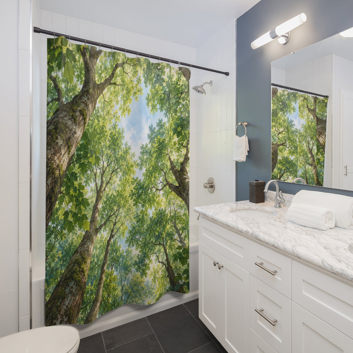 Green tree canopy around pale blue sky shower curtain beside a white vanity