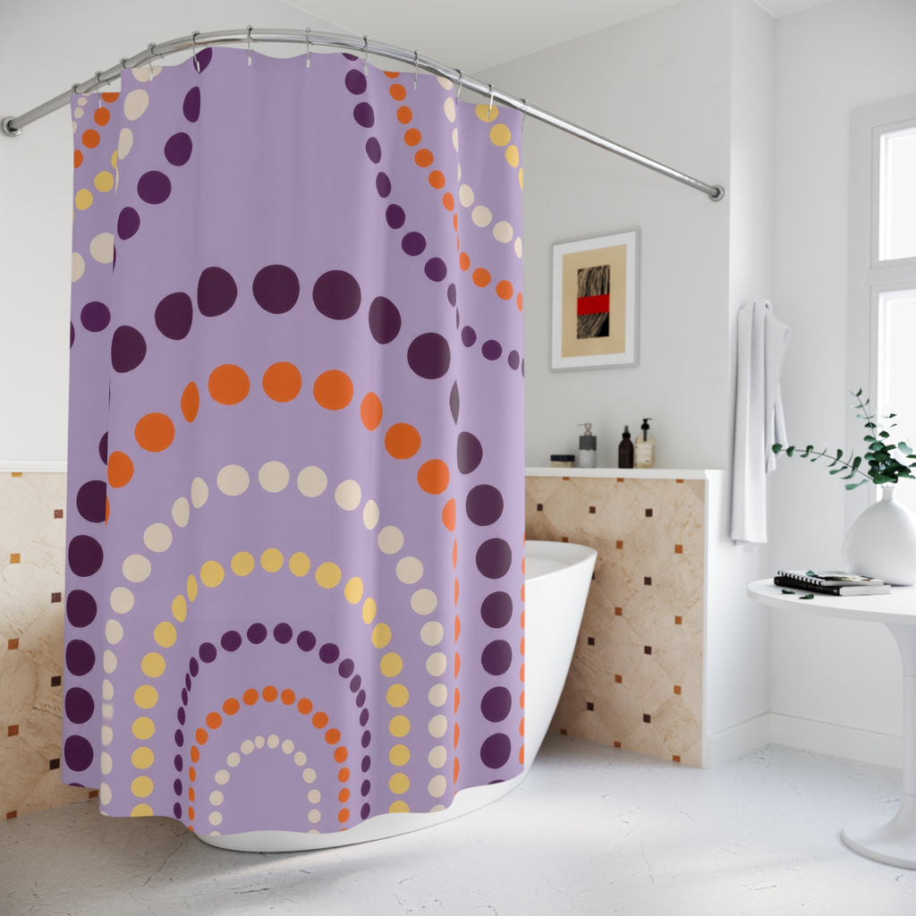 Purple polka dot arches with orange accents shower curtain beside a freestanding tub
