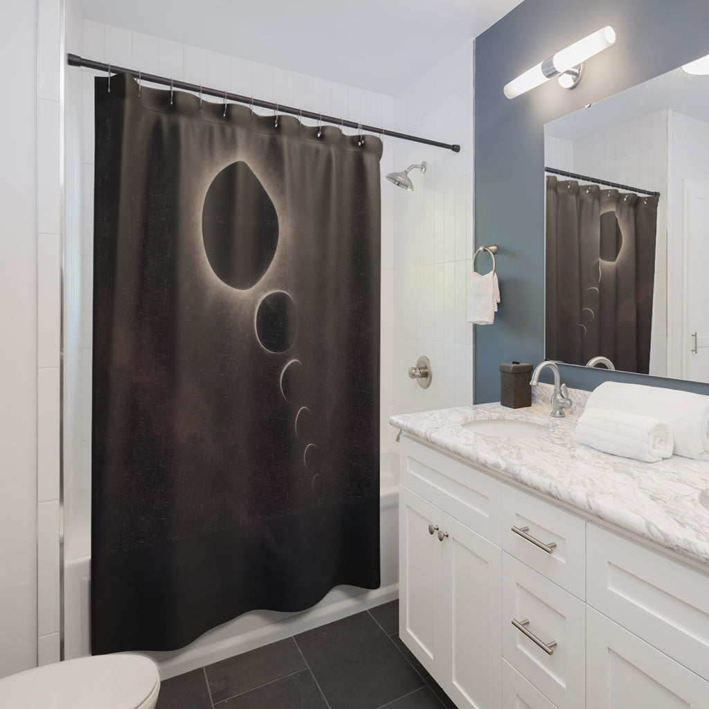 Charcoal eclipse with a silver halo and descending orbital forms shower curtain beside a white vanity