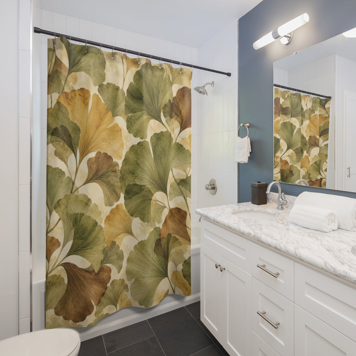 Olive and ochre ginkgo fans with brown leaves shower curtain beside a white vanity
