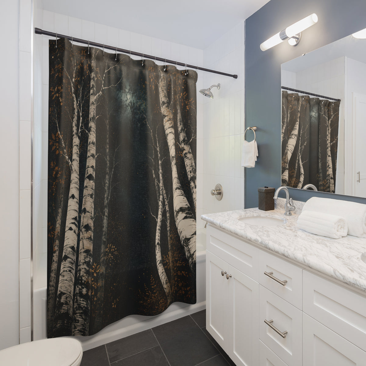 White birch nocturne with dark teal and amber shower curtain beside a white vanity