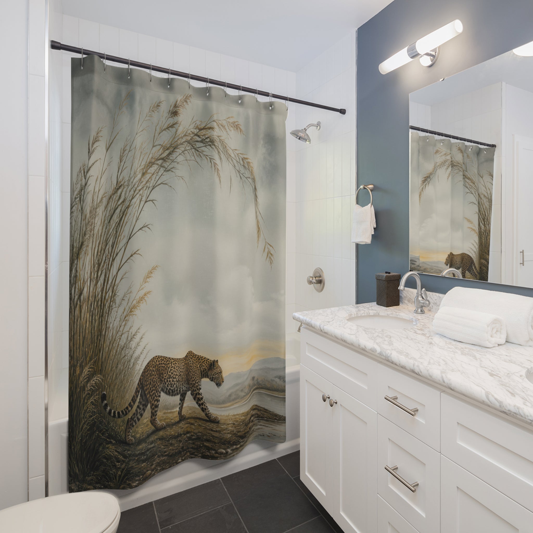 Misty grassland leopard landscape shower curtain beside a white vanity