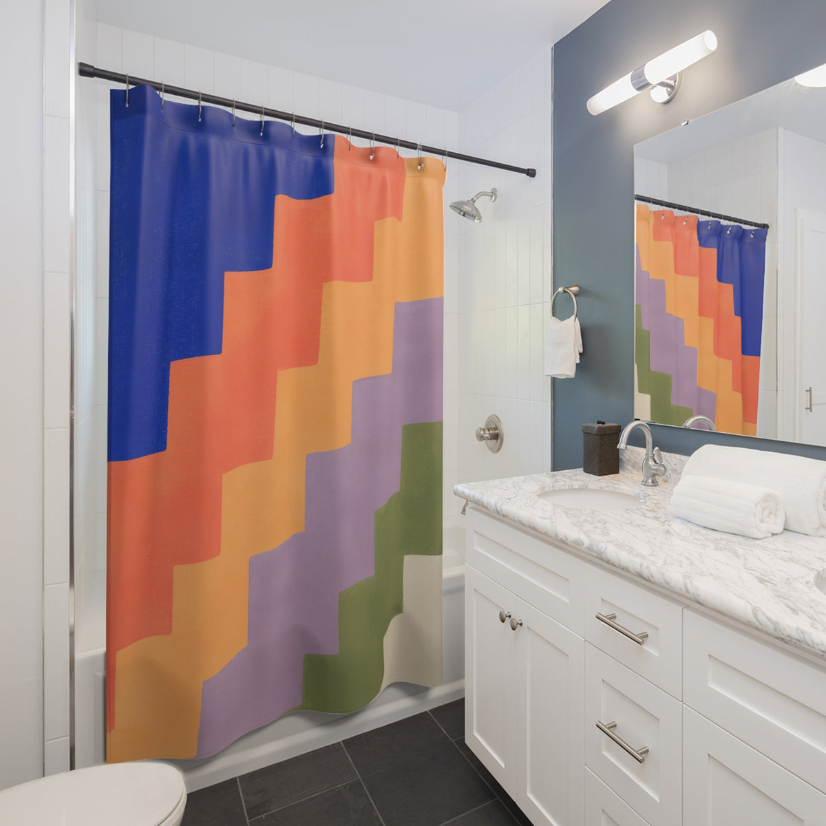Cobalt coral and lilac stepped color bands shower curtain beside a white vanity