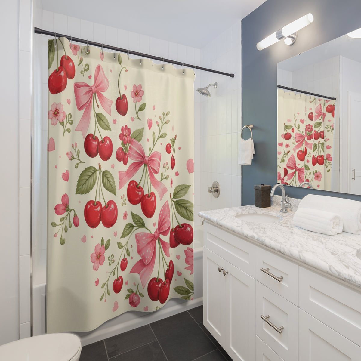 Red cherry clusters and pink bows sweeping across cream shower curtain beside a white vanity