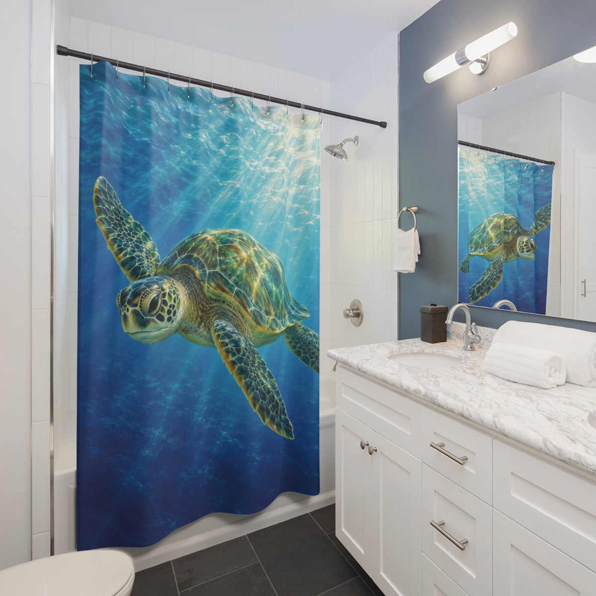 Jade sea turtle and blue underwater sunbeams shower curtain beside a white vanity