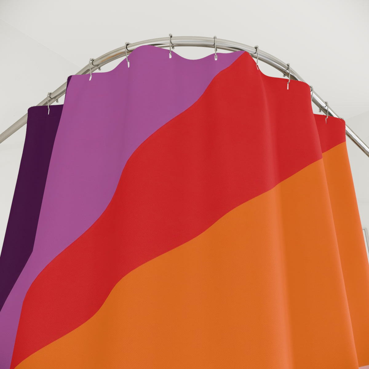 Plum orange and turquoise radial color panels shower curtain with close-up print, hooks, and folds