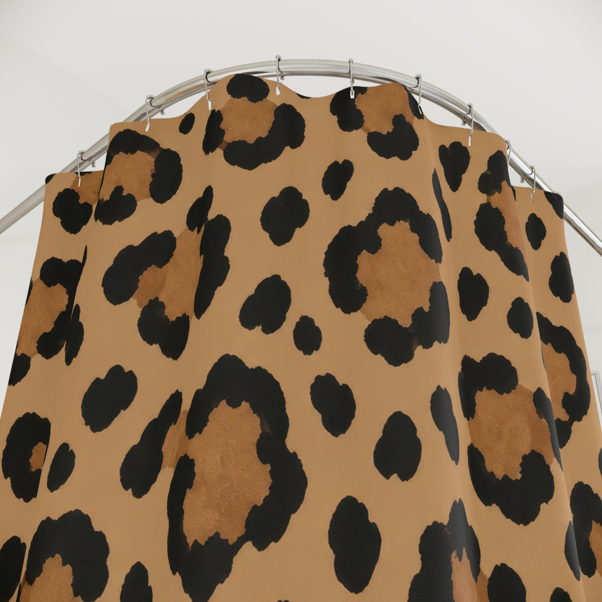 Black and tan leopard rosette shower curtain with close-up print, hooks, and folds