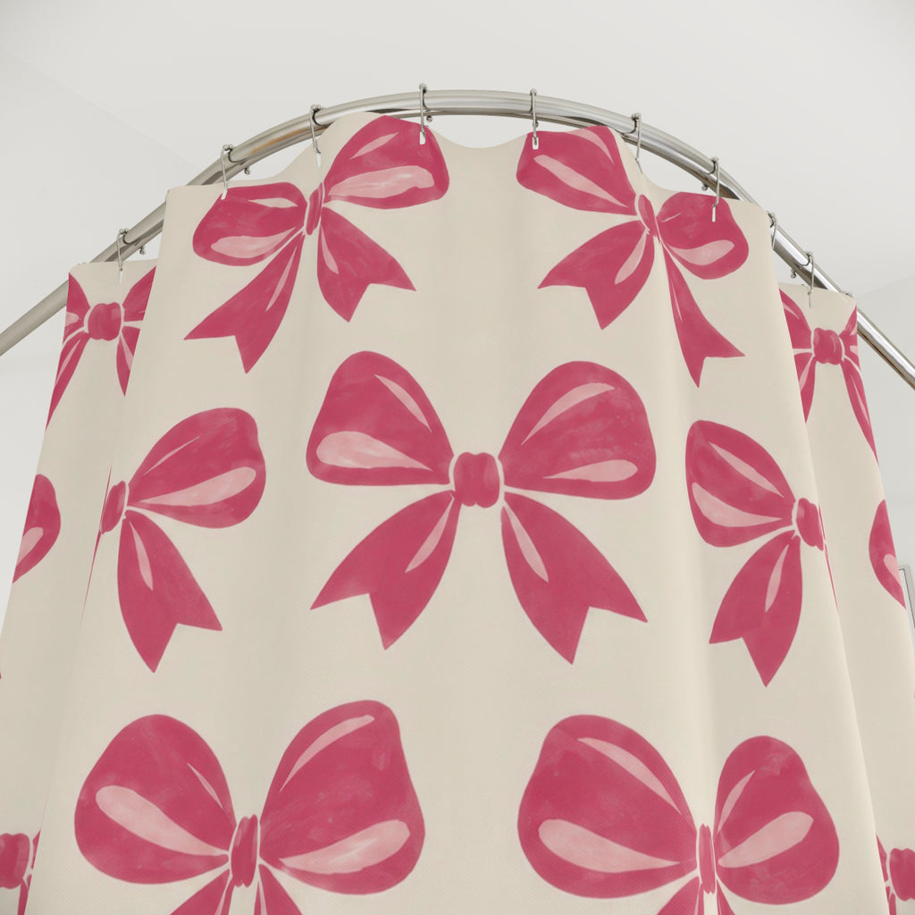 Pink bow pattern with raspberry loops on warm cream shower curtain with close-up print, hooks, and folds
