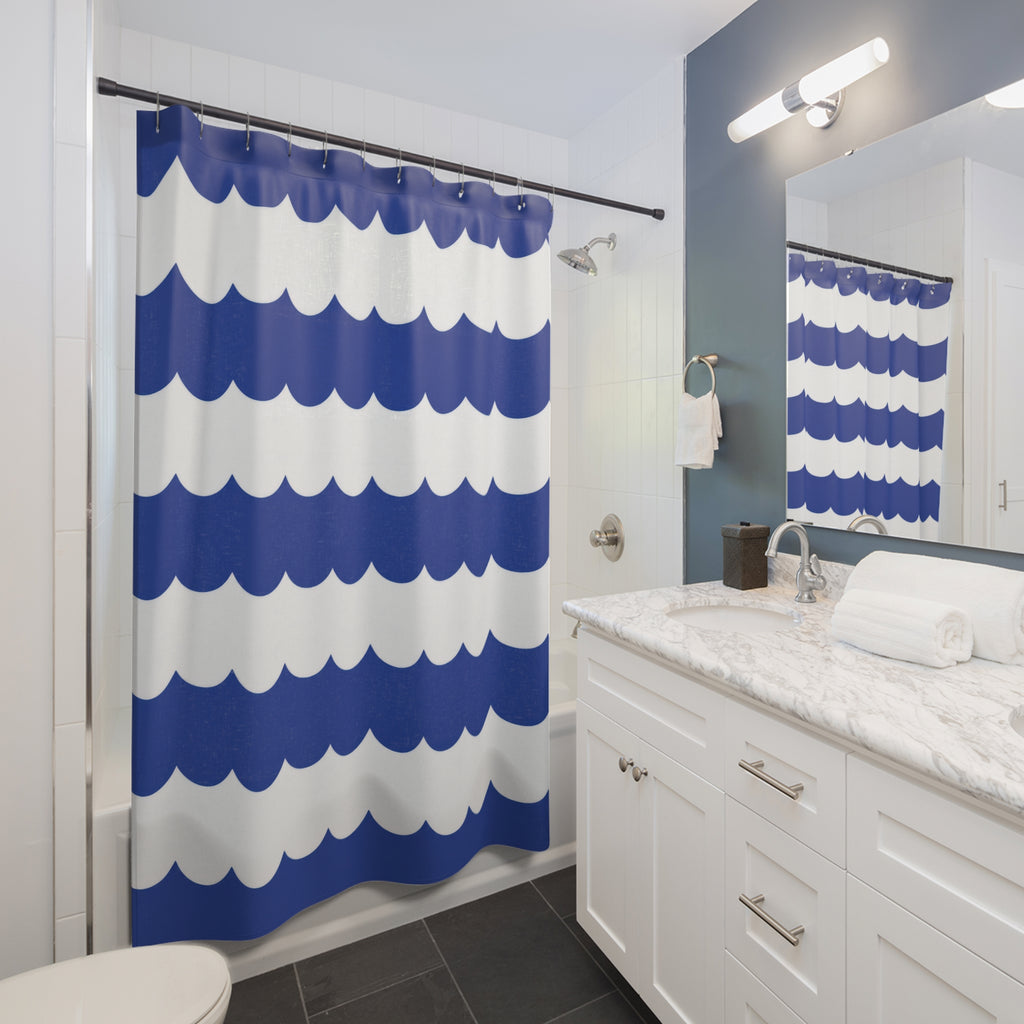 Cobalt and white horizontal scalloped stripes shower curtain beside a white vanity