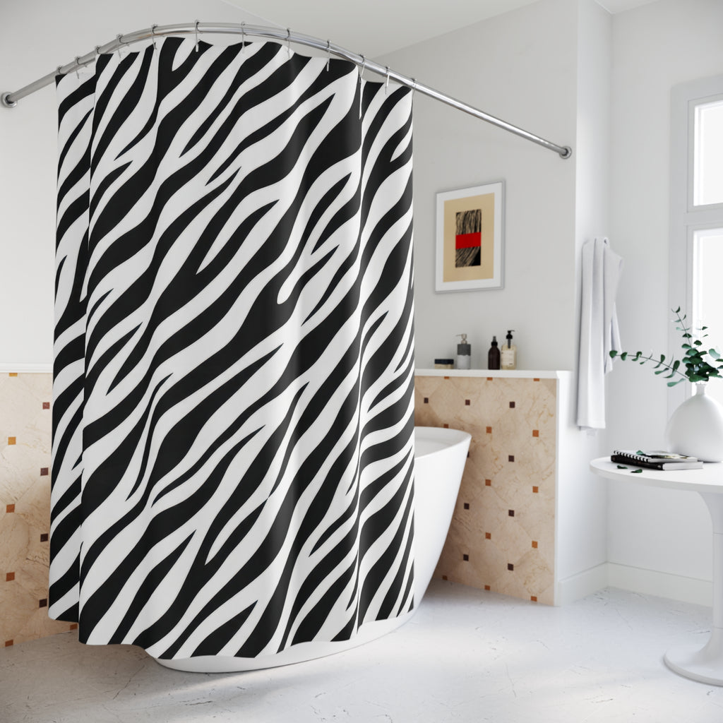 Diagonal black zebra stripes tapering across white shower curtain beside a freestanding tub