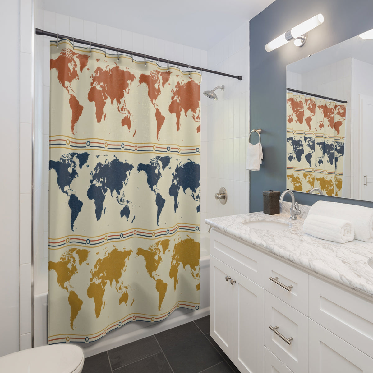 Rust, navy and mustard world maps in repeating rows shower curtain beside a white vanity