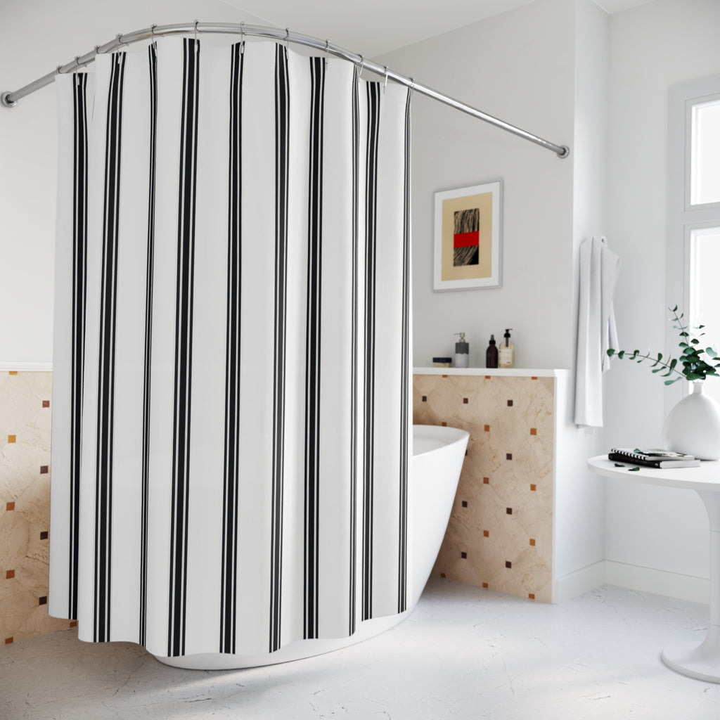 Fine black ticking stripe trios on white shower curtain beside a freestanding tub