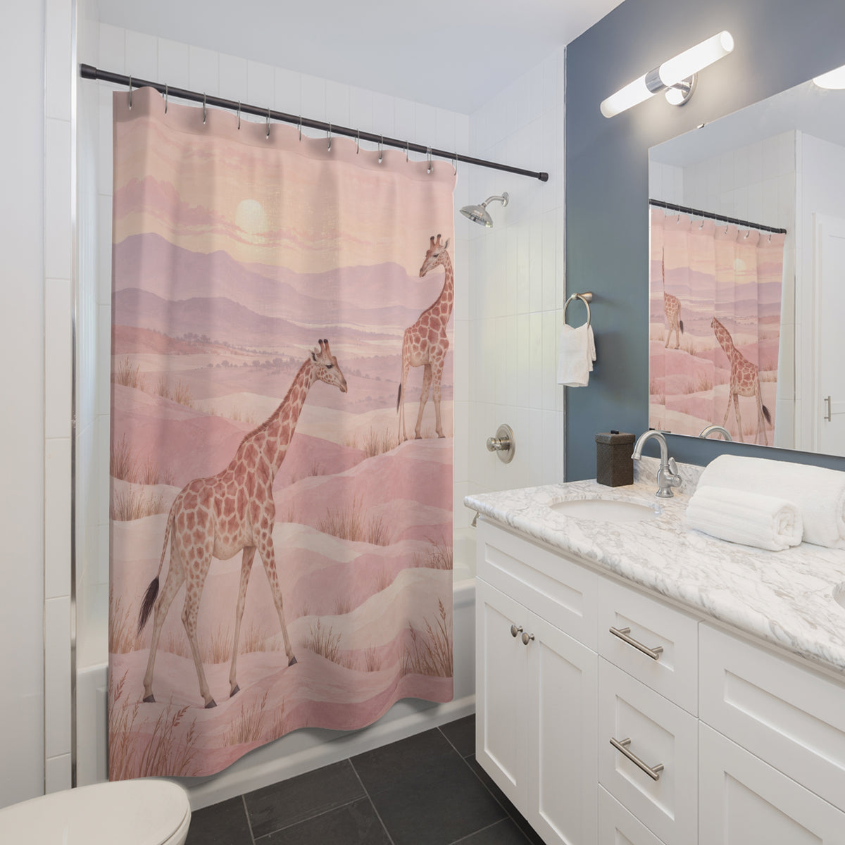 Two tan giraffes in a light pink hilly landscape shower curtain beside a white vanity