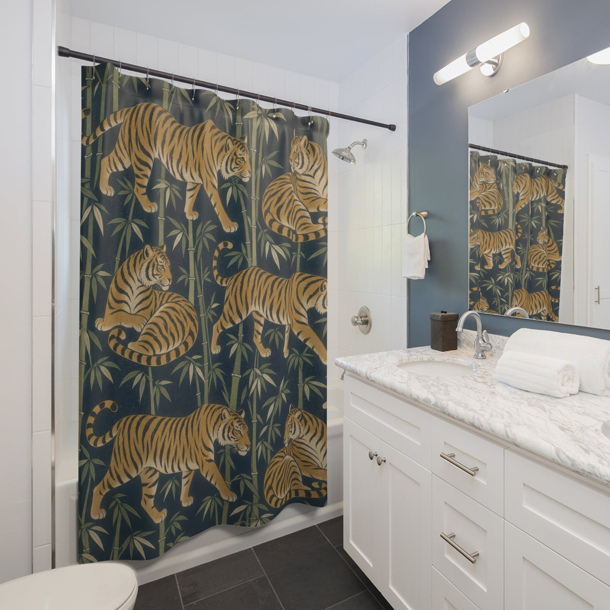 Ochre tiger and olive bamboo pattern on indigo shower curtain beside a white vanity
