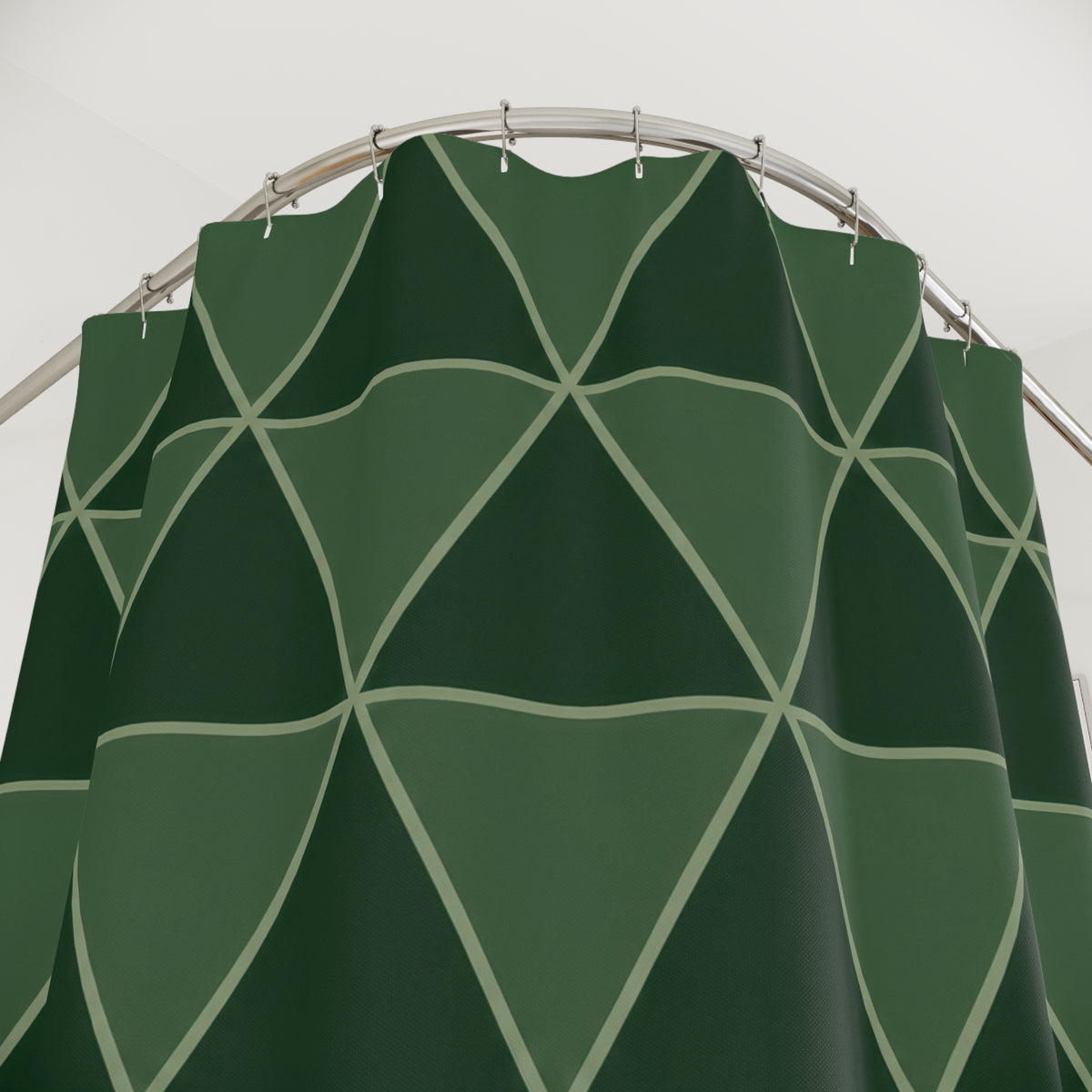Forest green triangles with sage outlines shower curtain with close-up print, hooks, and folds