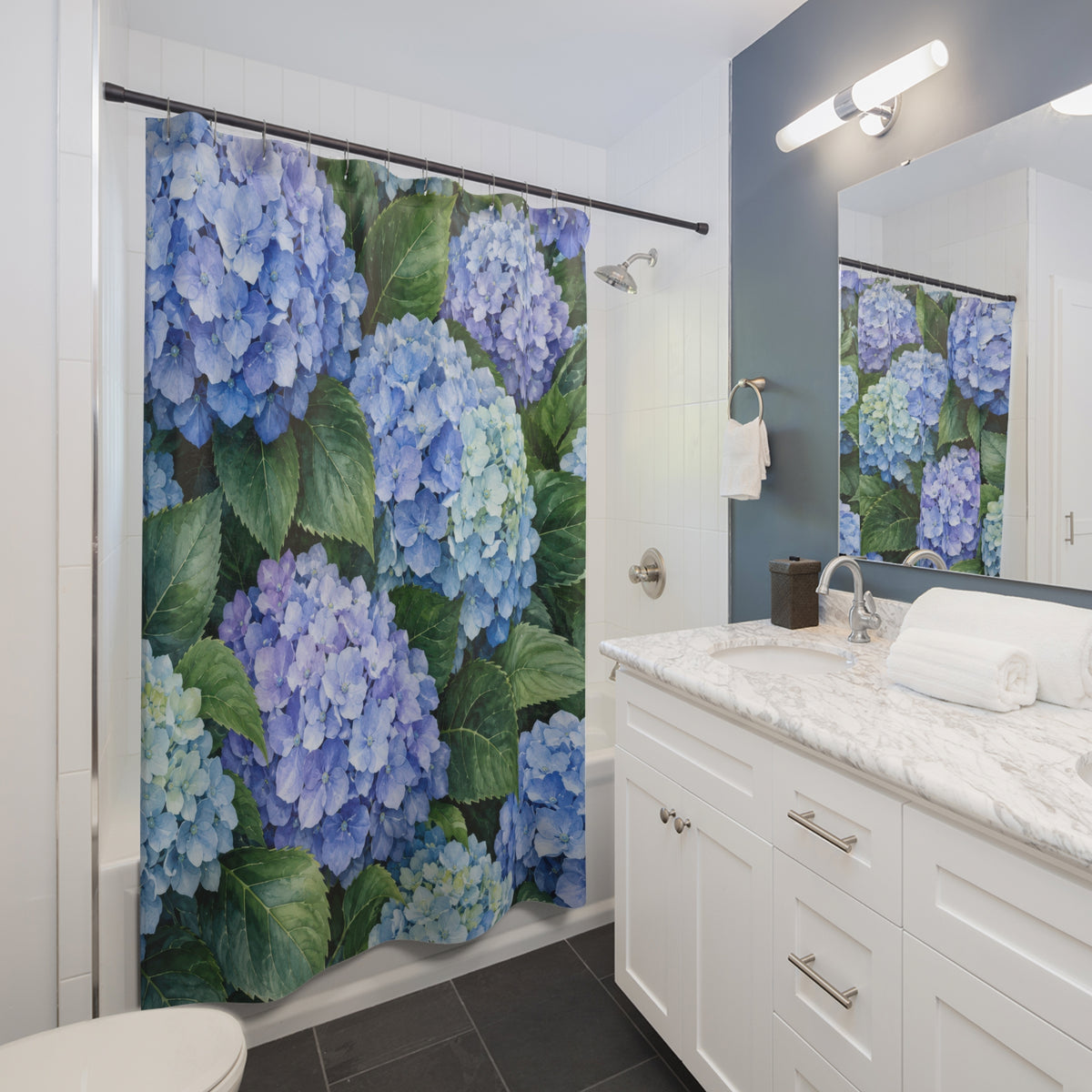 Blue hydrangea clusters among broad green leaves shower curtain beside a white vanity