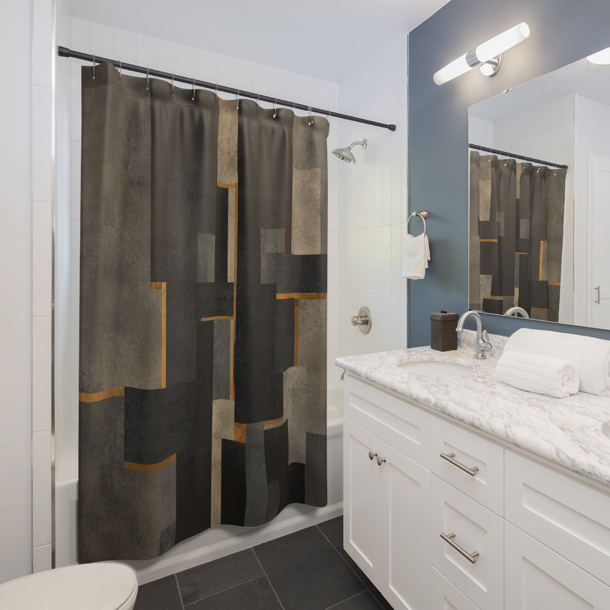 Charcoal brutalist blocks with narrow brass lines shower curtain beside a white vanity