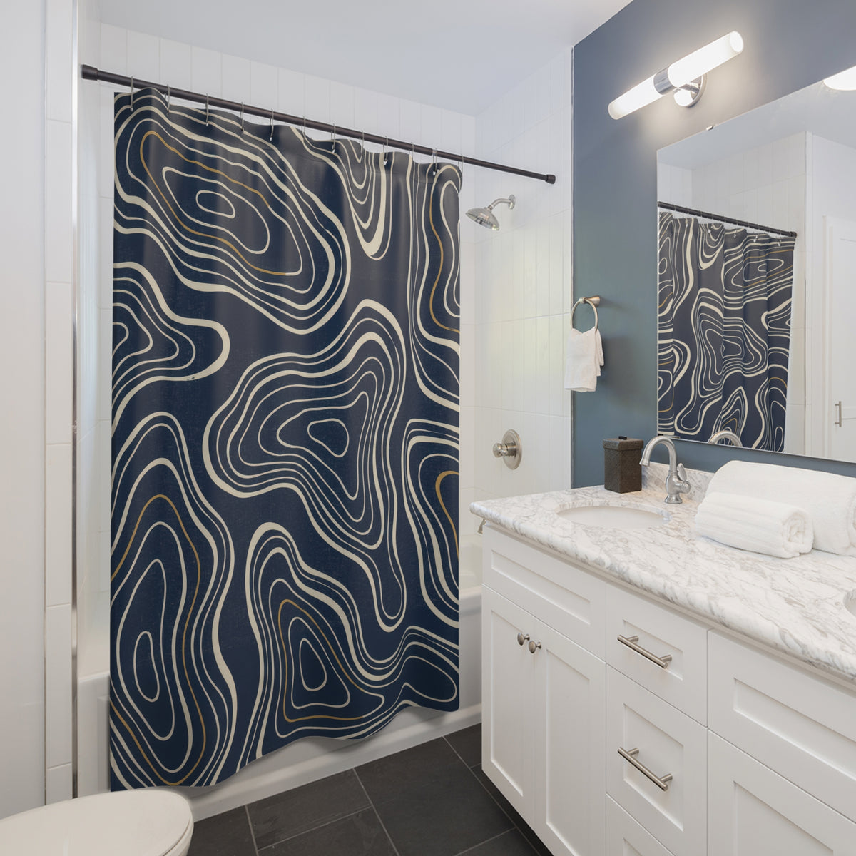Cream nested contours and ochre accents on navy shower curtain beside a white vanity