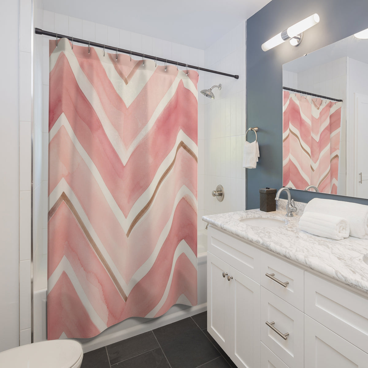 Painted blush pink and ivory chevrons with tan accents shower curtain beside a white vanity