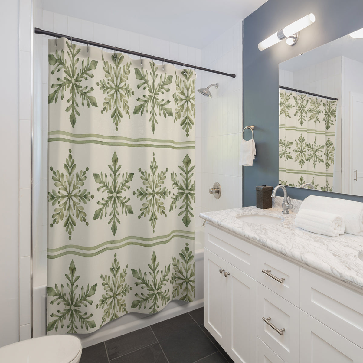 Sage leafy snowflakes in cream bands with green stripes shower curtain beside a white vanity