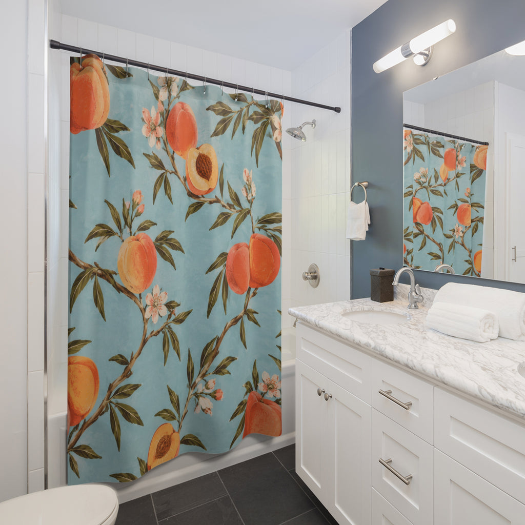 Peaches and leafy branches on pale blue shower curtain beside a white vanity