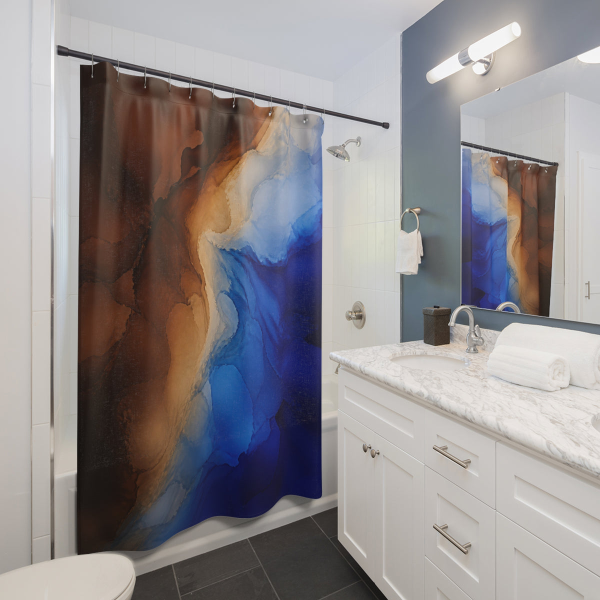 Cobalt blue and brown flowing abstract ink washes shower curtain beside a white vanity