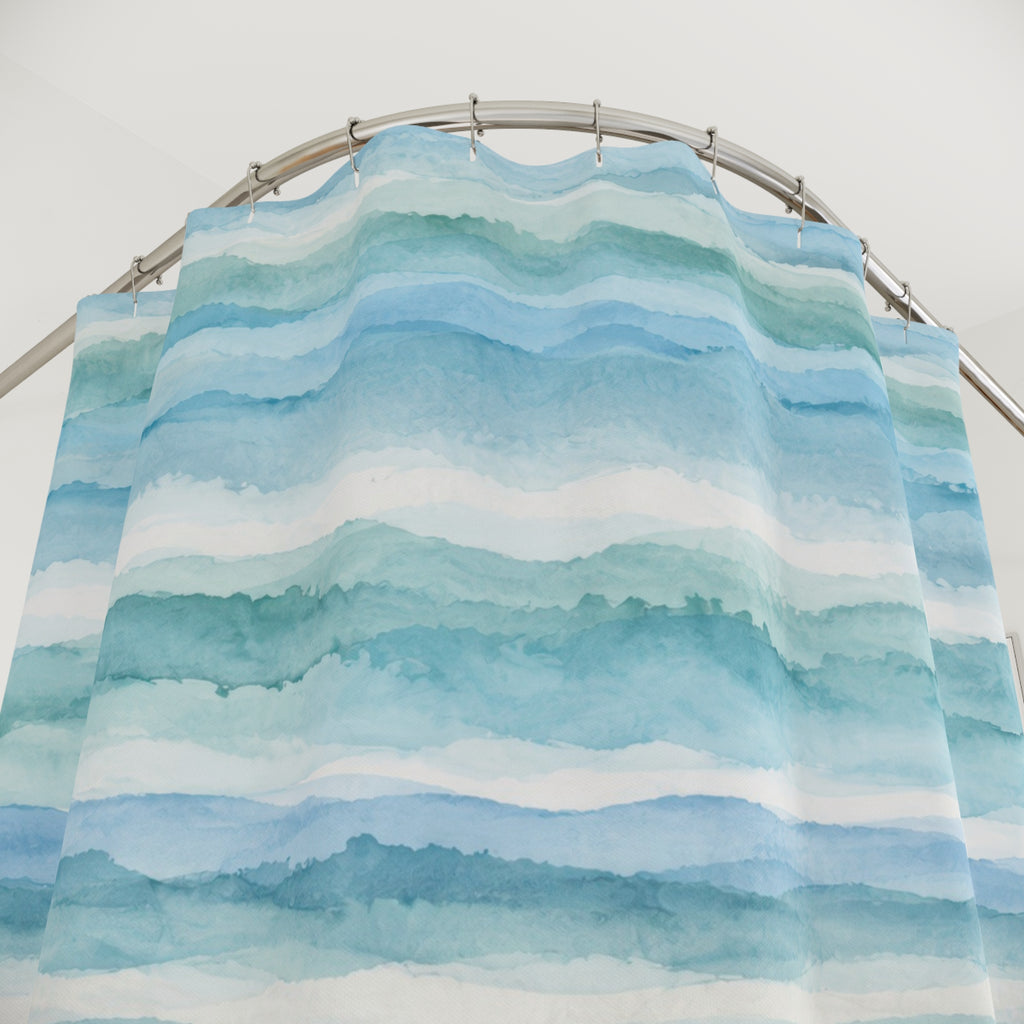 Watercolor bands of aqua and teal deepening to blue below shower curtain with close-up print, hooks, and folds