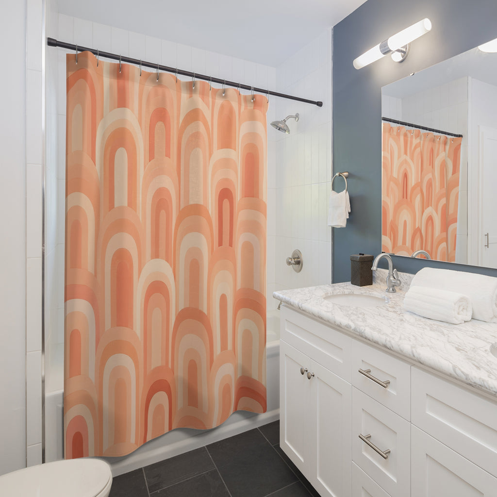 Peachy apricot and cream arches shower curtain beside a white vanity
