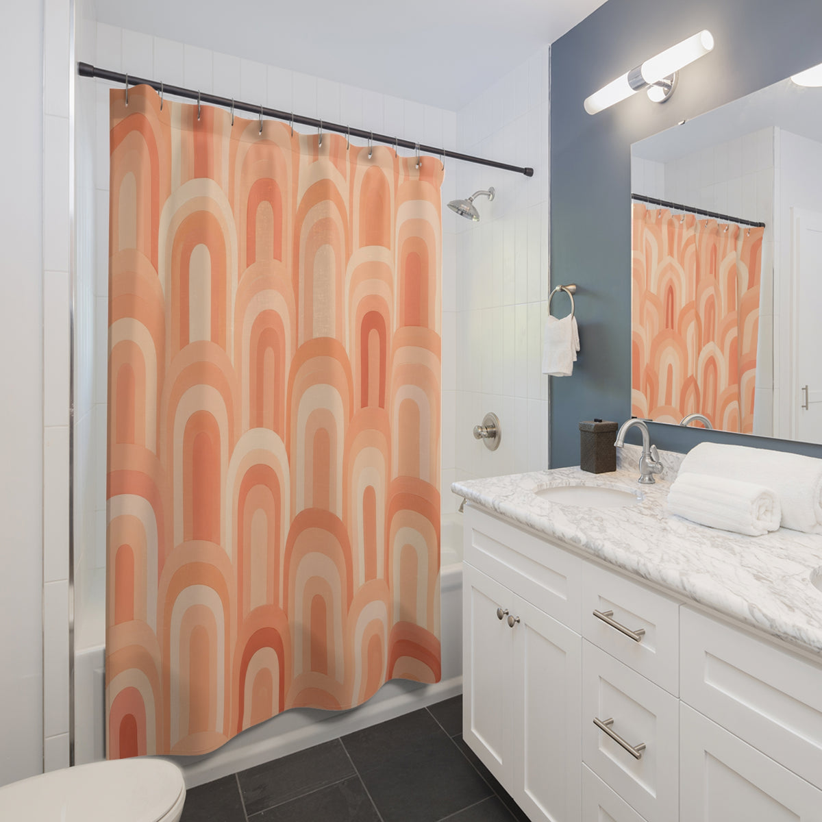 Peachy apricot and cream arches shower curtain beside a white vanity