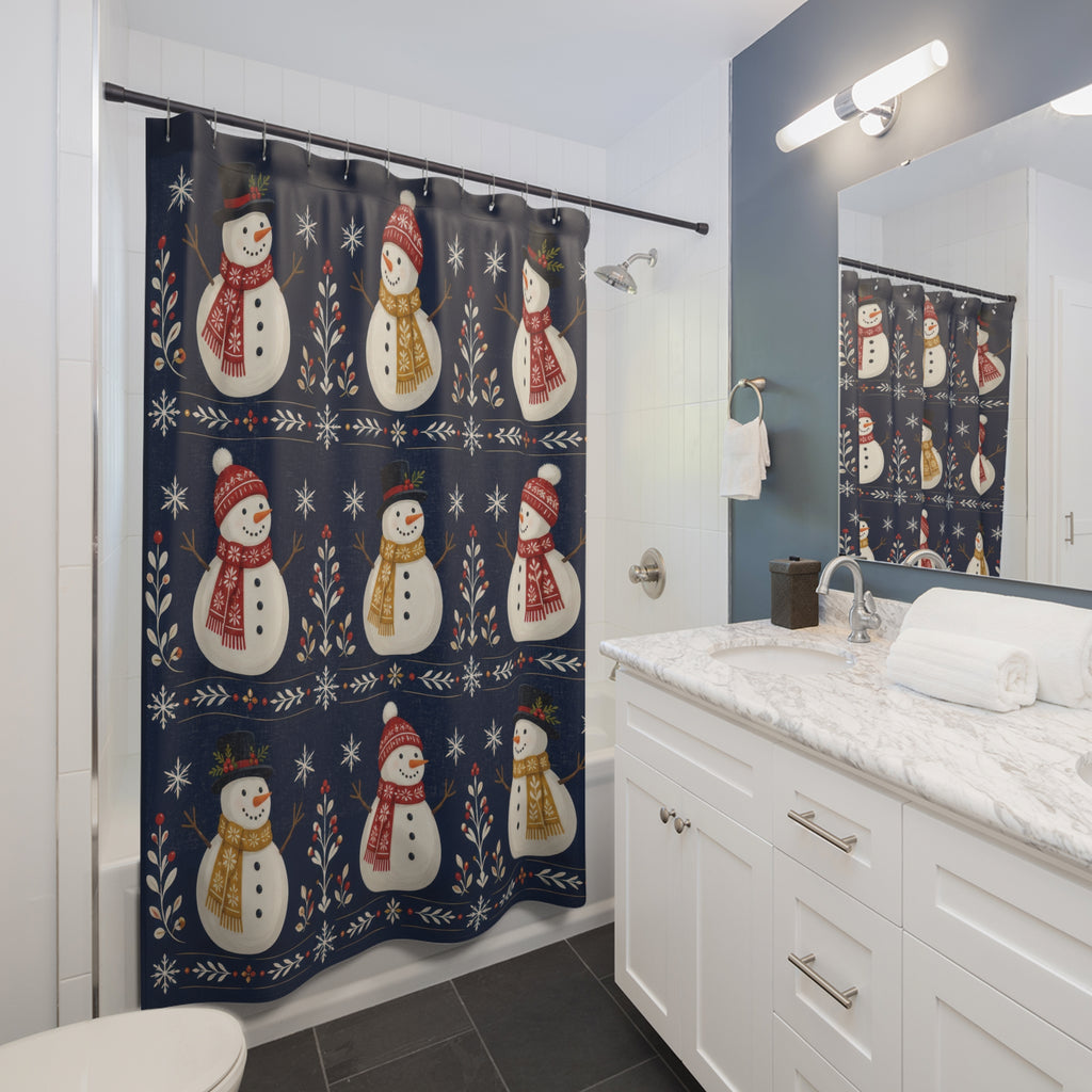 Ivory snowmen with red and gold scarves on navy shower curtain beside a white vanity