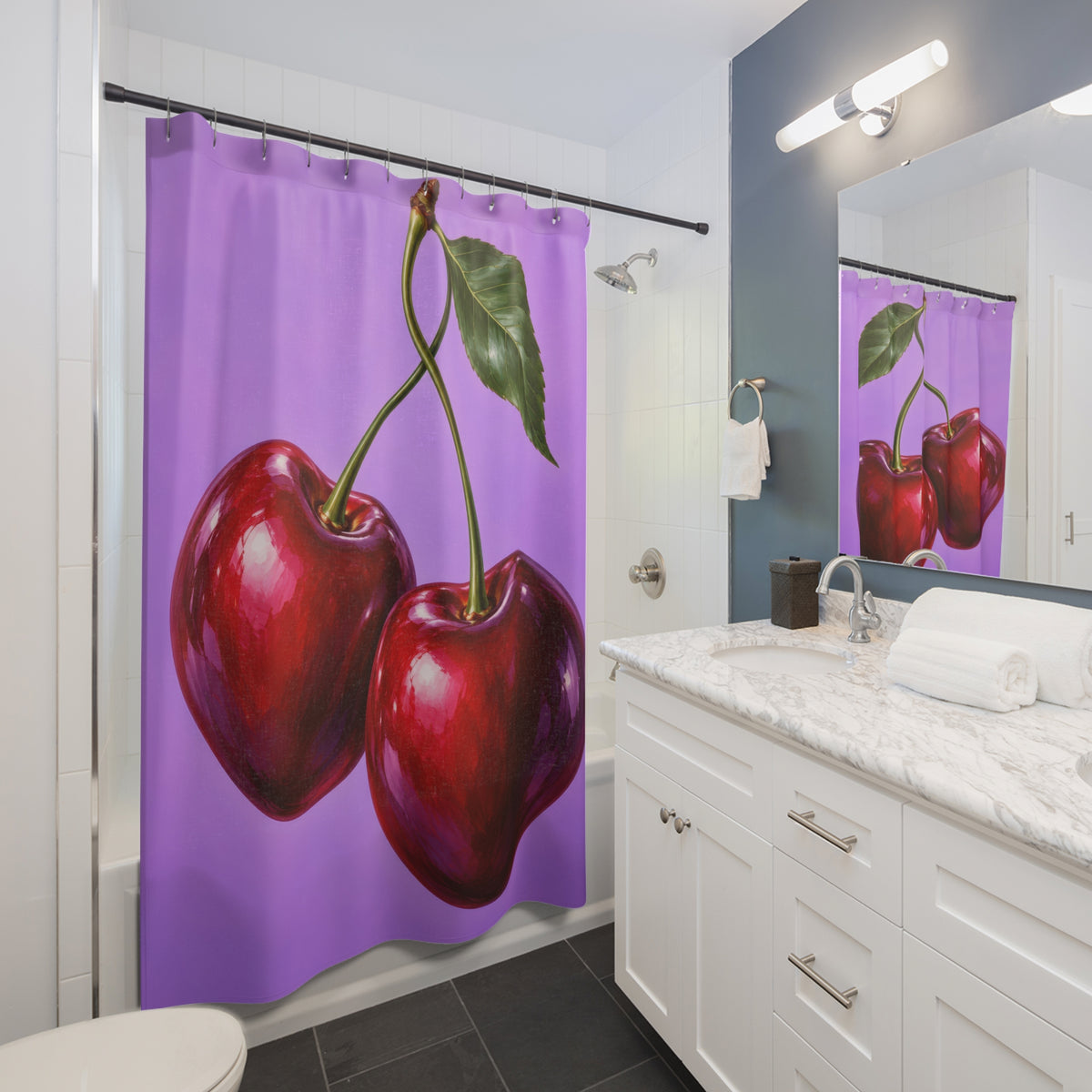 Two glossy red cherries with green stems on lilac shower curtain beside a white vanity