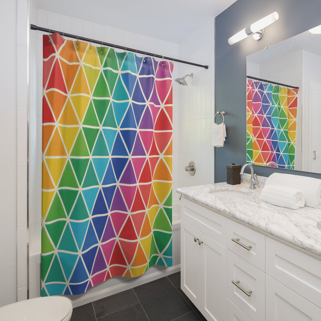 Rainbow triangles separated by slim ivory lines shower curtain beside a white vanity