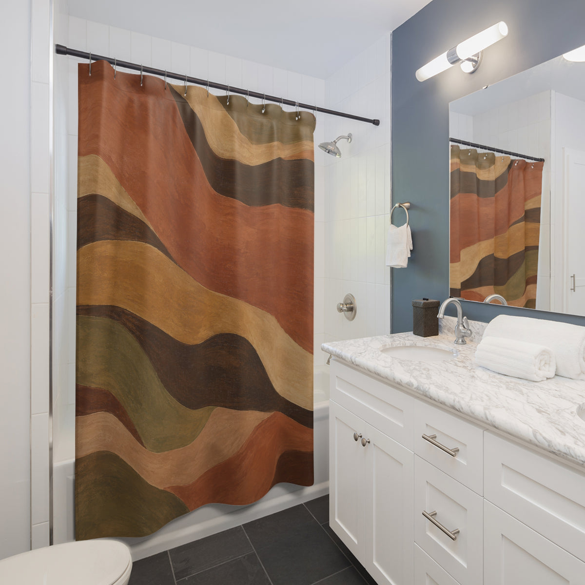 Terracotta and olive flowing bands with dark brown curves shower curtain beside a white vanity