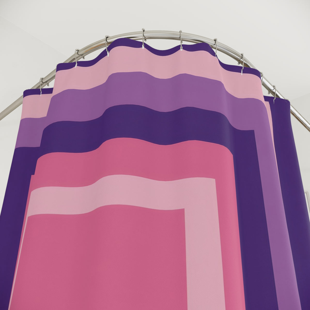 Nested rectangular stripes in pink, orchid and deep violet shower curtain with close-up print, hooks, and folds