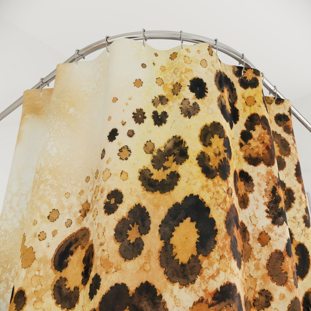 Tawny watercolor cheetah print on warm cream shower curtain with close-up print, hooks, and folds