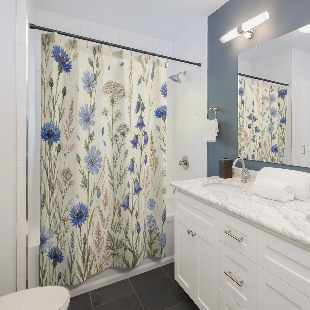 Blue wild flower field with cornflowers bellflowers and grasses shower curtain beside a white vanity