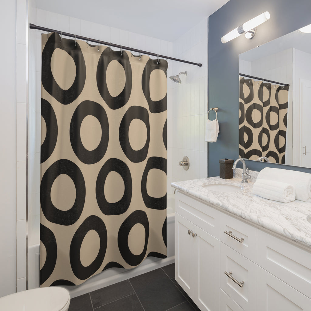 Beige and black open circles shower curtain beside a white vanity