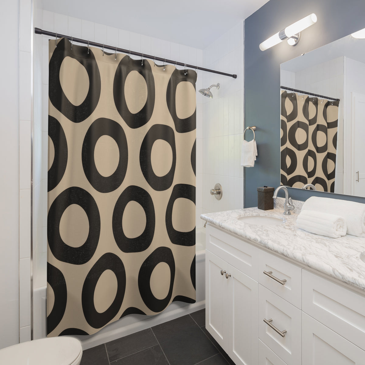 Beige and black open circles shower curtain beside a white vanity