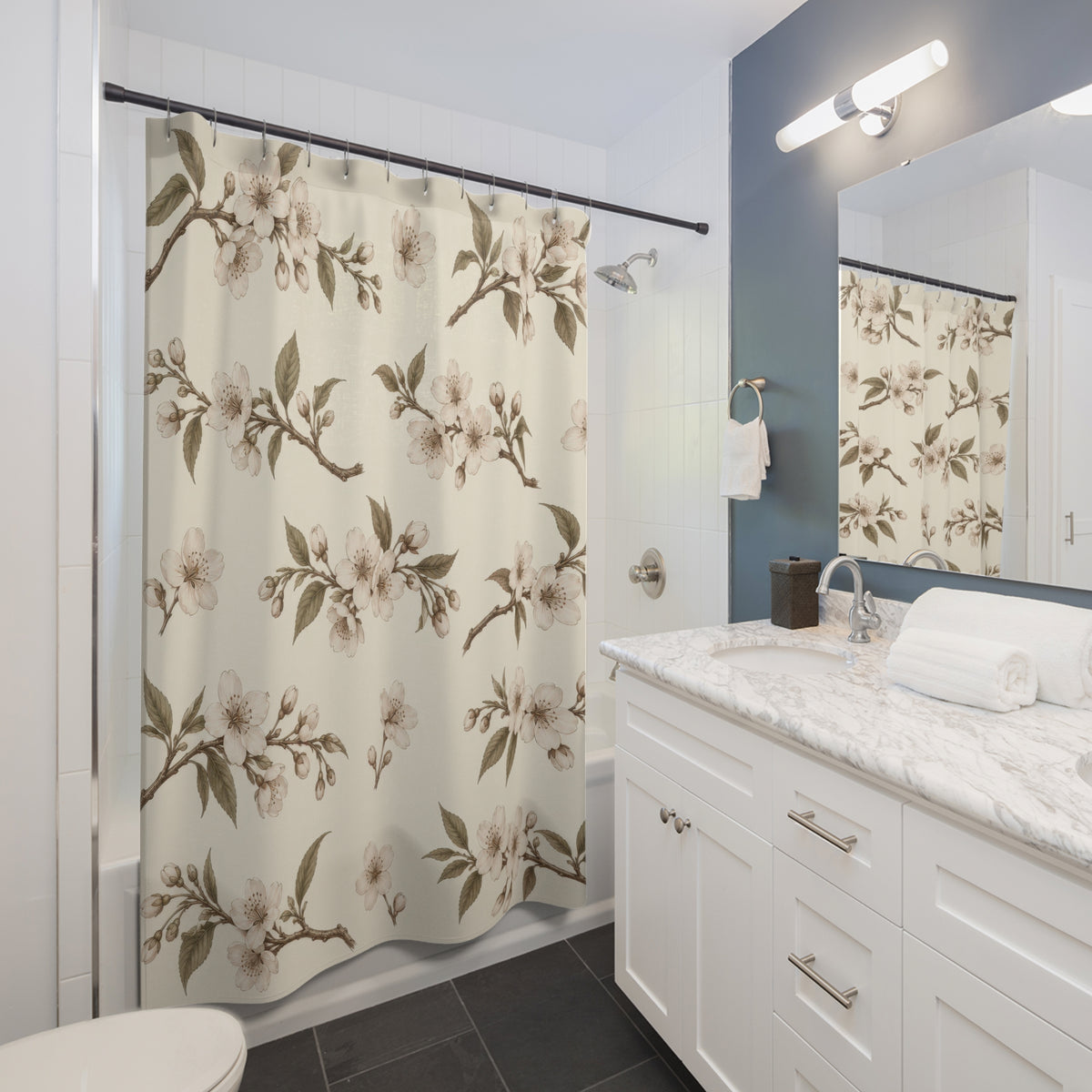 Sepia cherry blossom boughs with olive leaves on ivory shower curtain beside a white vanity