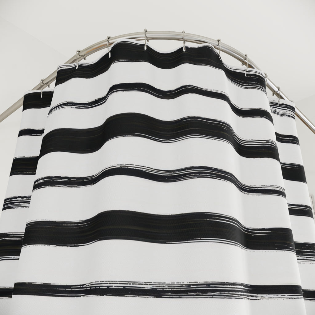 Horizontal black brush stripes with dry ink edges on white shower curtain with close-up print, hooks, and folds