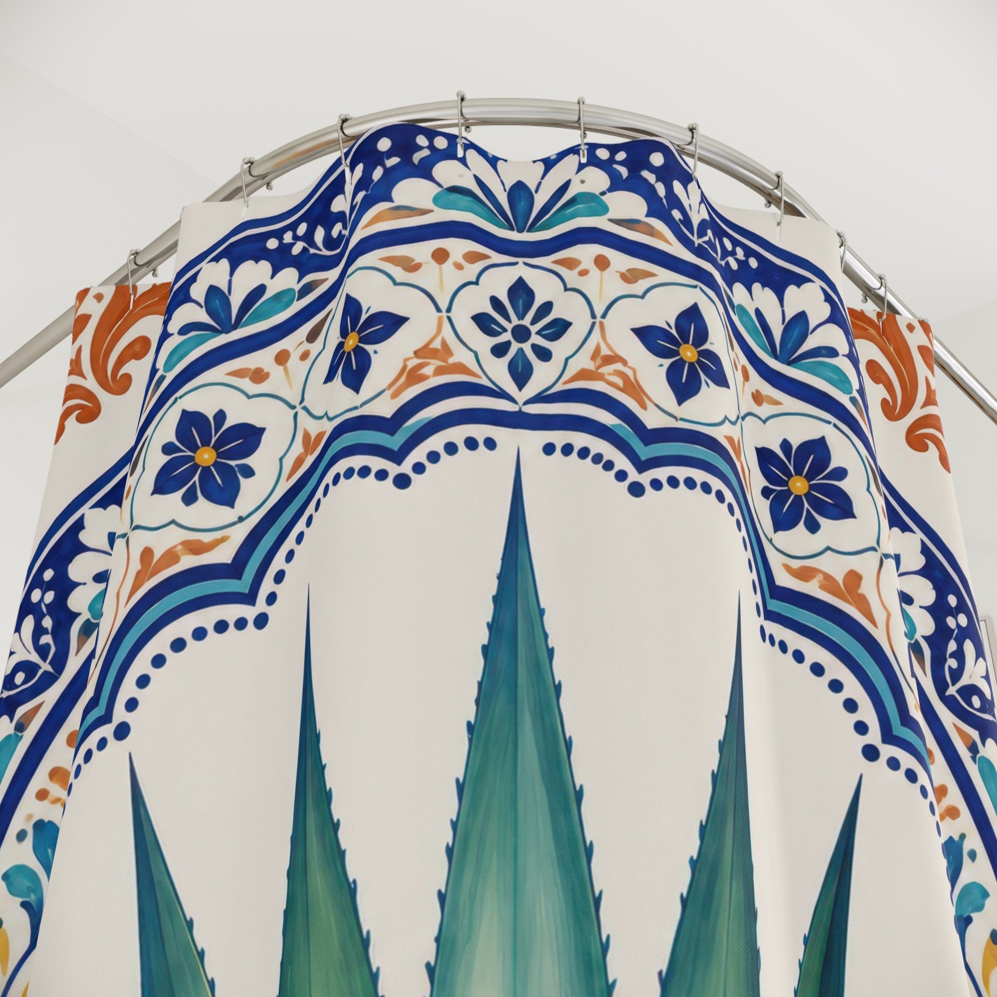 Green agave in a cobalt ornamental arch shower curtain with close-up print, hooks, and folds