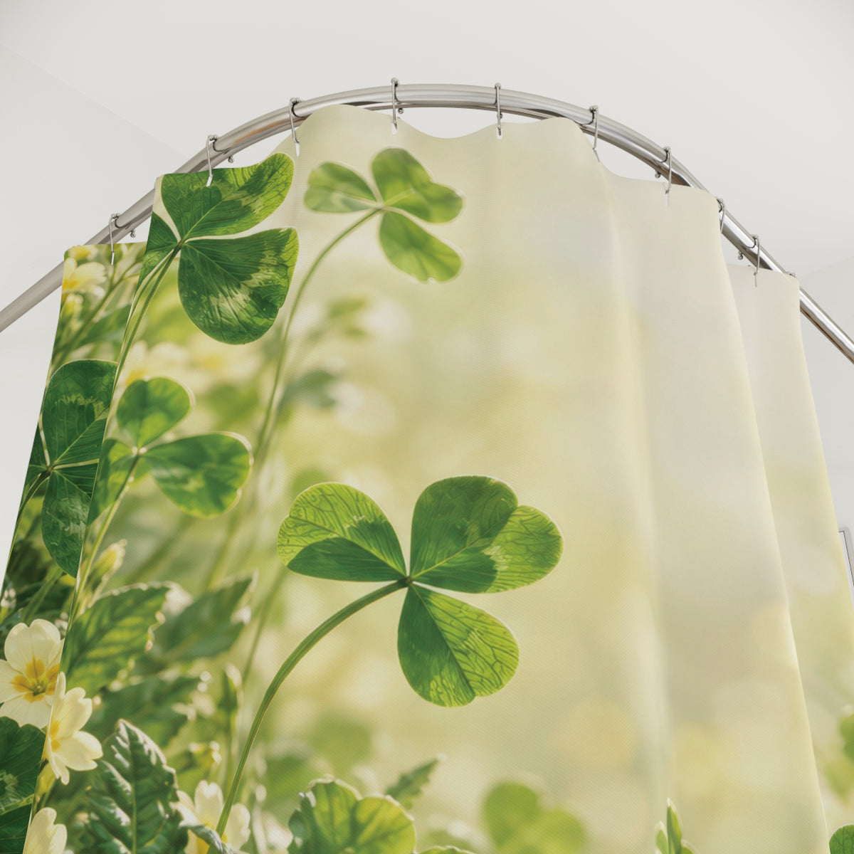 Green clover and pale yellow primrose meadow shower curtain with close-up print, hooks, and folds