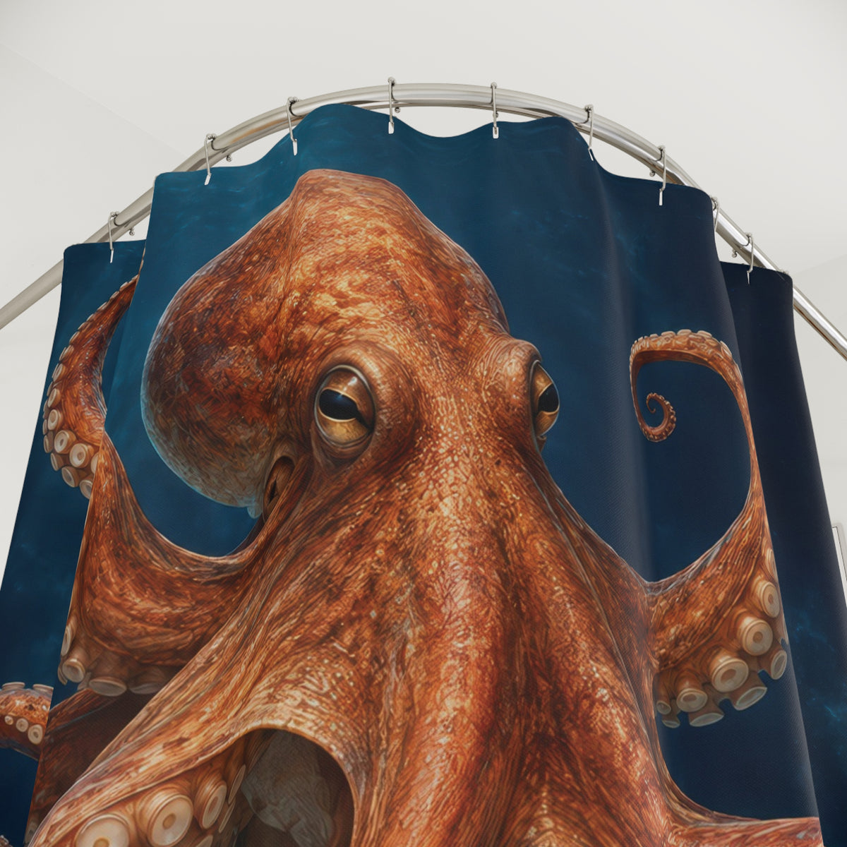 Copper-orange octopus with pale suction cups in deep blue water shower curtain with close-up print, hooks, and folds