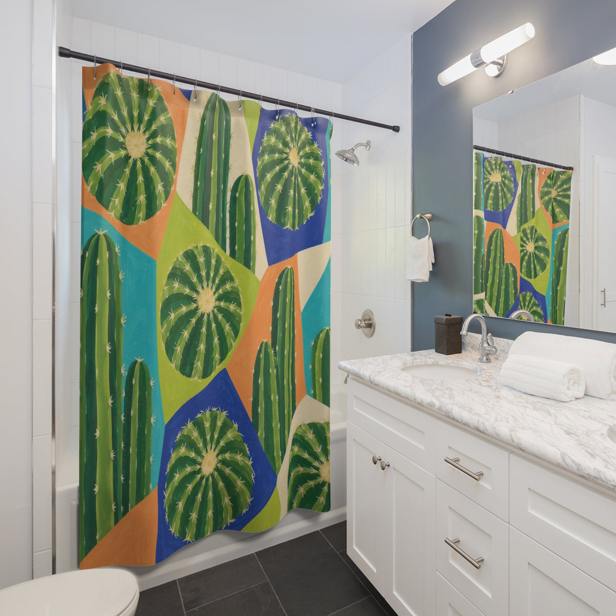 Green barrel and column cactus in colorful geometric panels shower curtain beside a white vanity