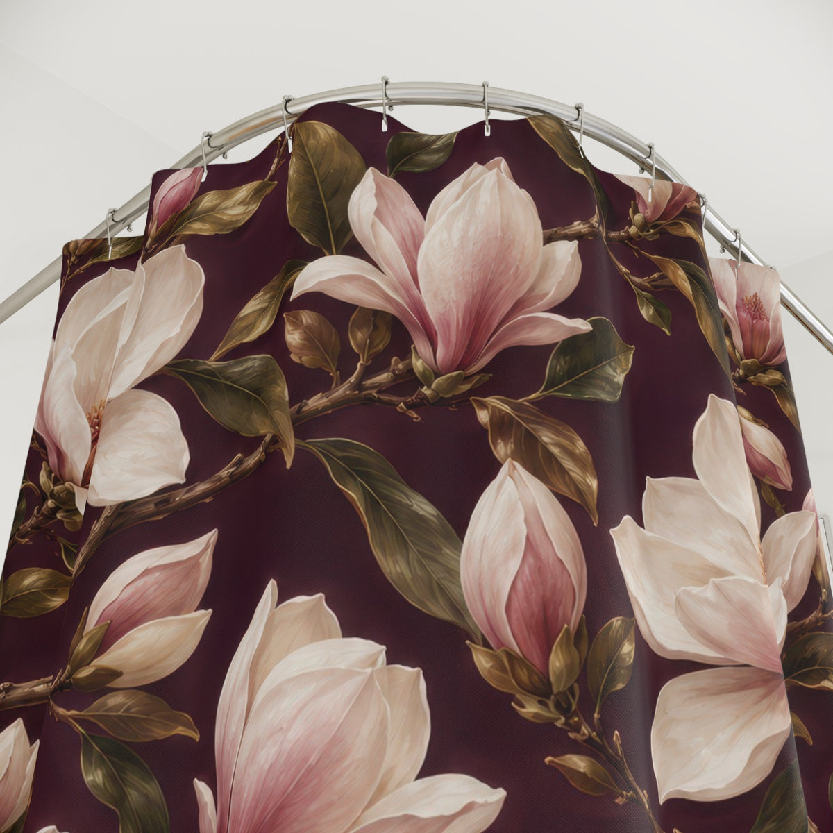 Cream magnolias and olive leaves on wine plum shower curtain with close-up print, hooks, and folds