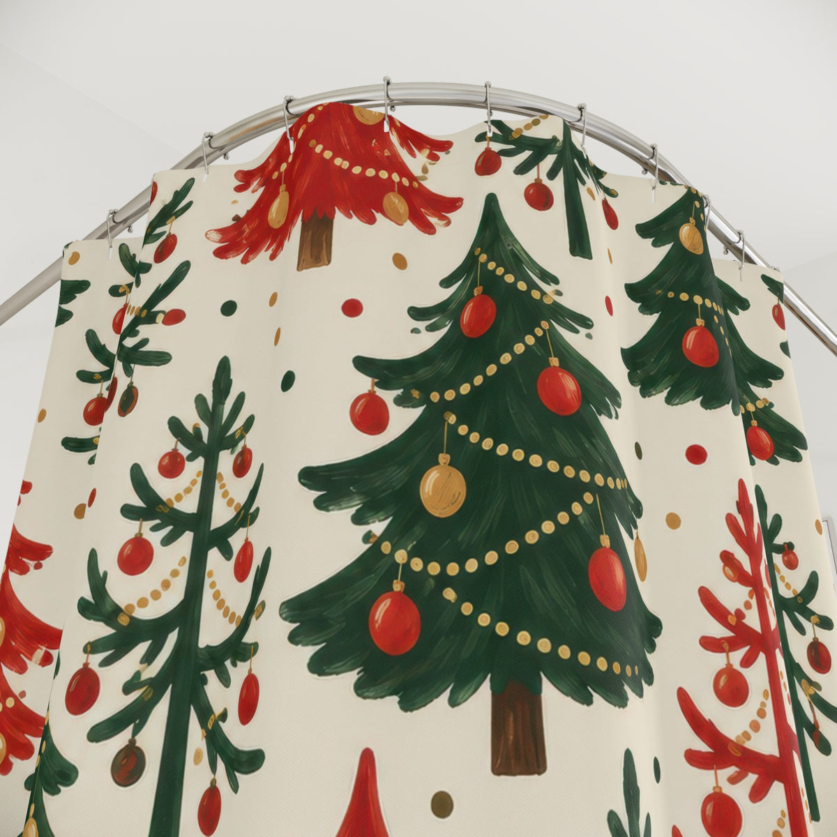 Red and green Christmas trees with gold garlands on ivory shower curtain with close-up print, hooks, and folds